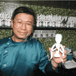 A man holding up a toy in front of a counter, demonstrating its features.