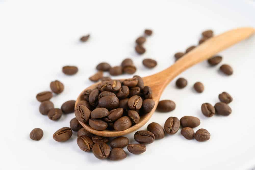 coffee-beans-wooden-spoon-white-wood-table-small