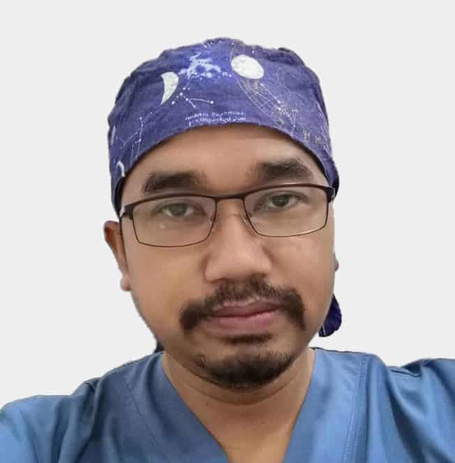 A man wearing a blue scrub cap and a blue bandana.